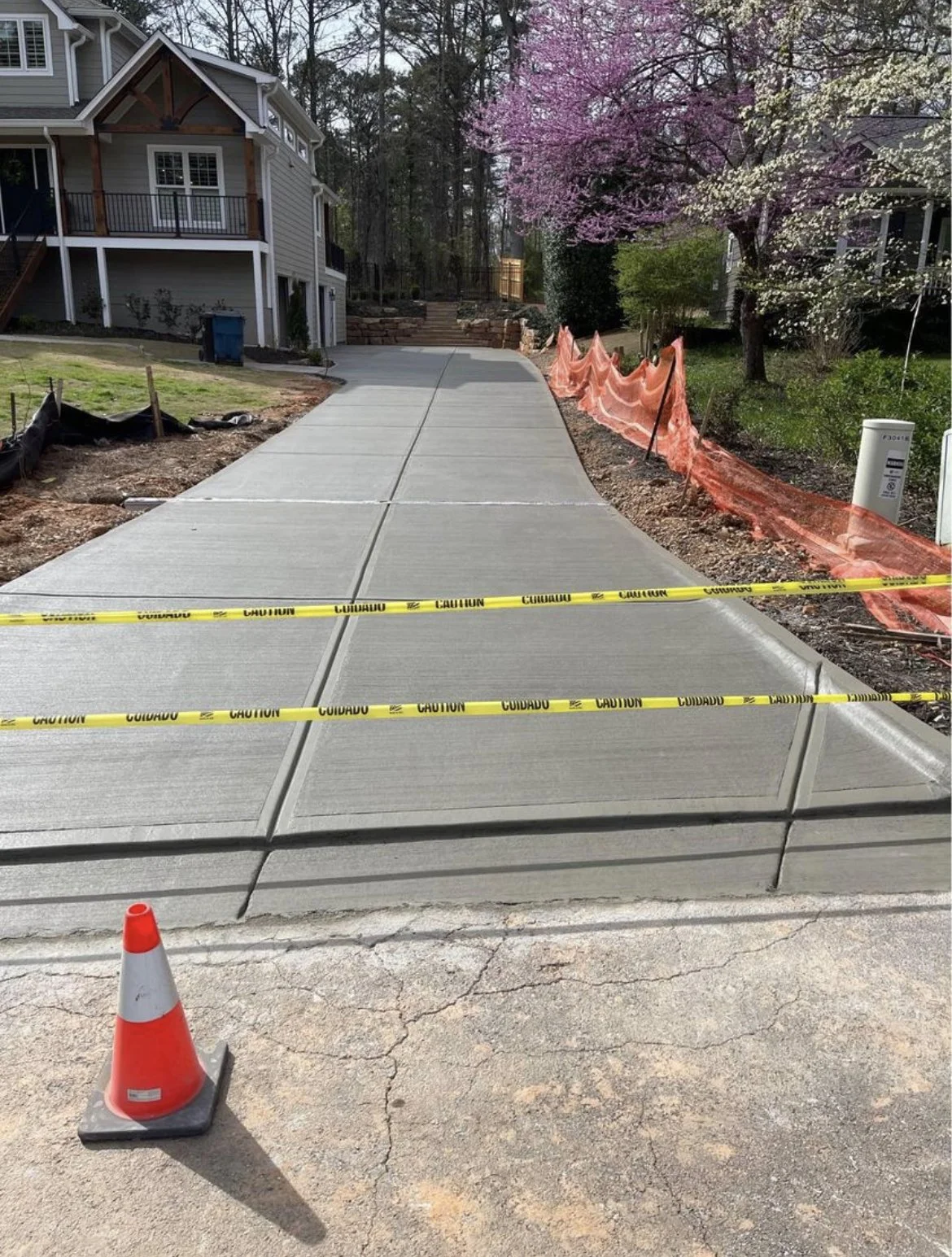 New broom-finished concrete driveway pour at a residential home